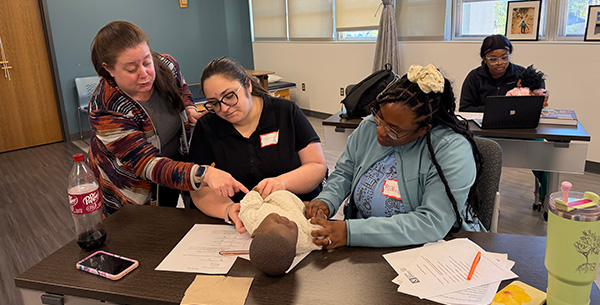 MGA Occupational Therapy Students working with Emory Experts on baby dummy